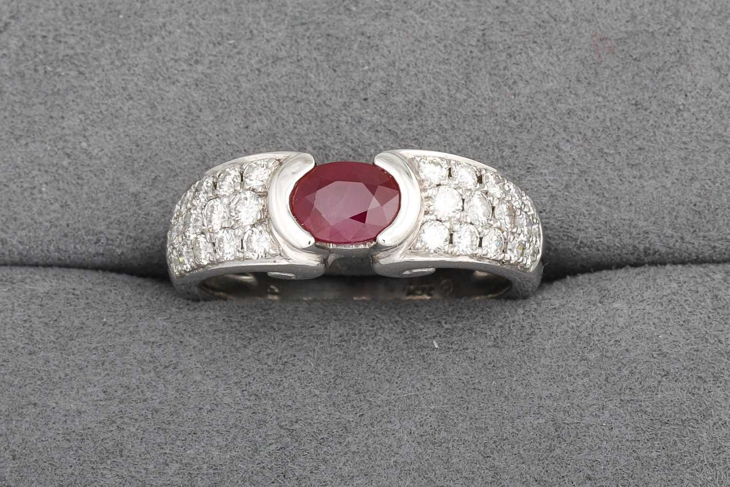 Lot 8 - A RUBY AND DIAMOND RING, the oval ruby to pavé...