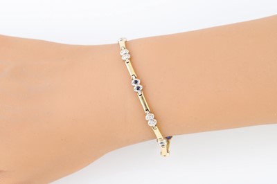 Lot 10 - A DIAMOND AND SAPPHIRE BRACELET, the...