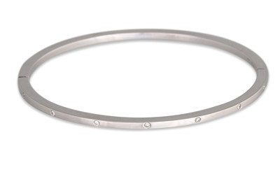 Lot 335 - AN 18CT GOLD WHITE BANGLE, set with diamonds,...