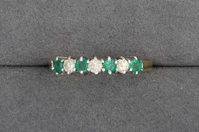 Lot 17 - A DIAMOND AND EMERALD RING, mounted in 18ct...