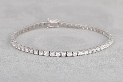 Lot 156 - A DIAMOND LINE BRACELET, mounted in 18ct white...
