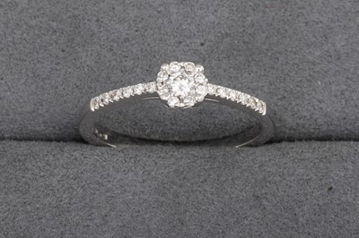 A DIAMOND CLUSTER RING, with diamond set...