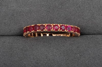 Lot 86 - A RUBY FULL ETERNITY RING, mounted in 14ct...