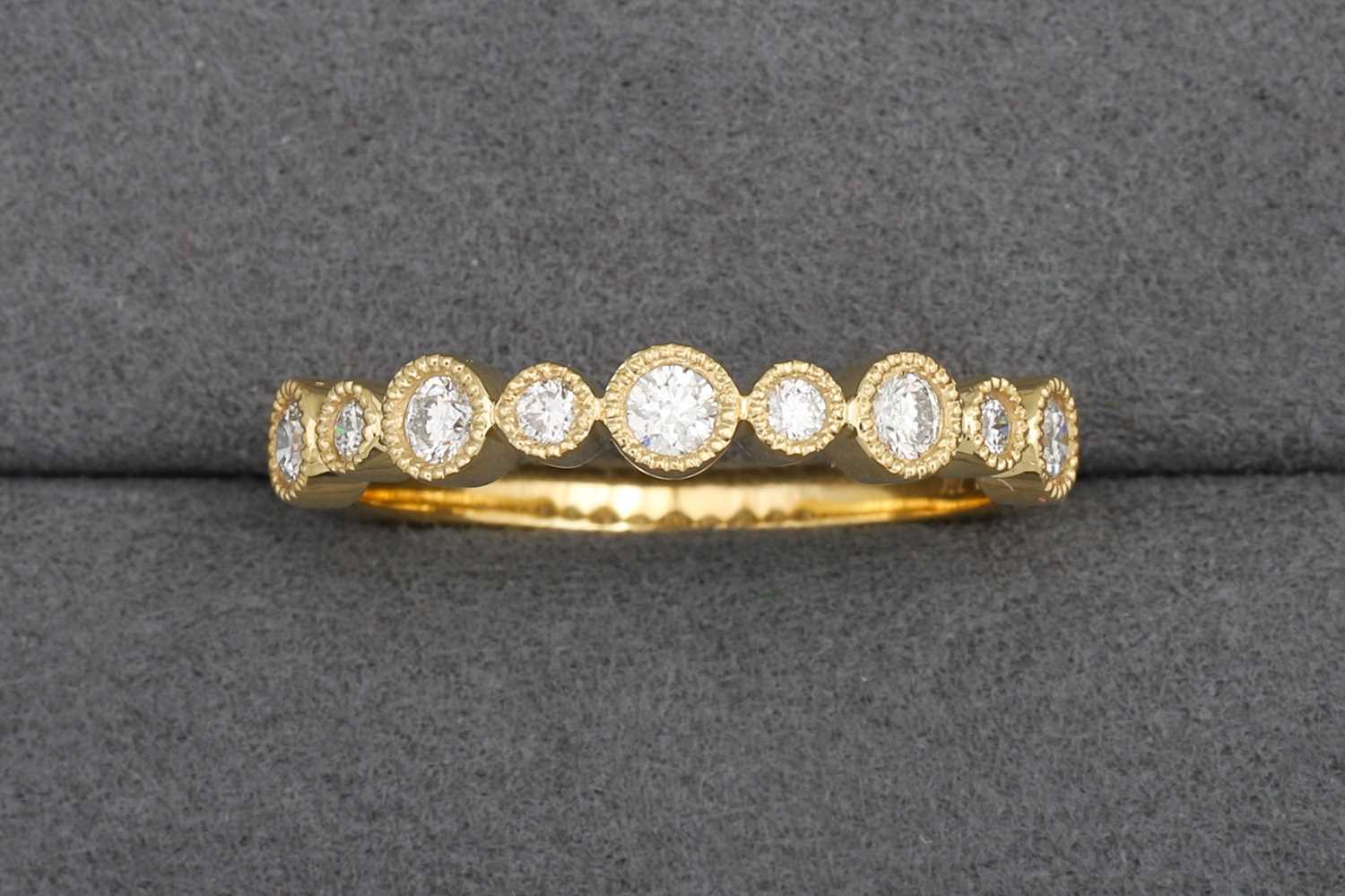A DIAMOND HALF ETERNITY RING, collet set...