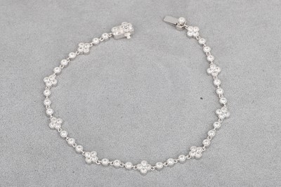 Lot 94 - A DIAMOND SET BRACELET, with collet set...