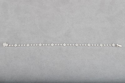 Lot 94 - A DIAMOND SET BRACELET, with collet set...