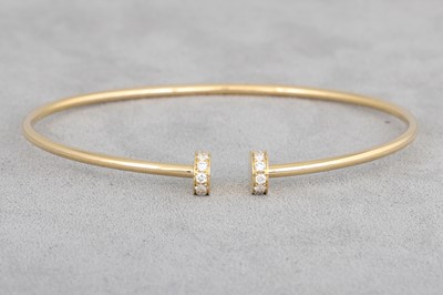 Lot 153 - A DIAMOND SET BANGLE, of open work form, in...
