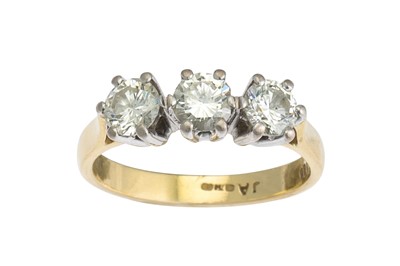 Lot 1 - A THREE STONE DIAMOND RING, the brilliant cut...
