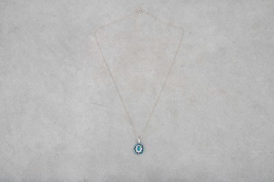 Lot 154 - A BLUE TOPAZ AND DIAMOND CLUSTER PENDANT,...