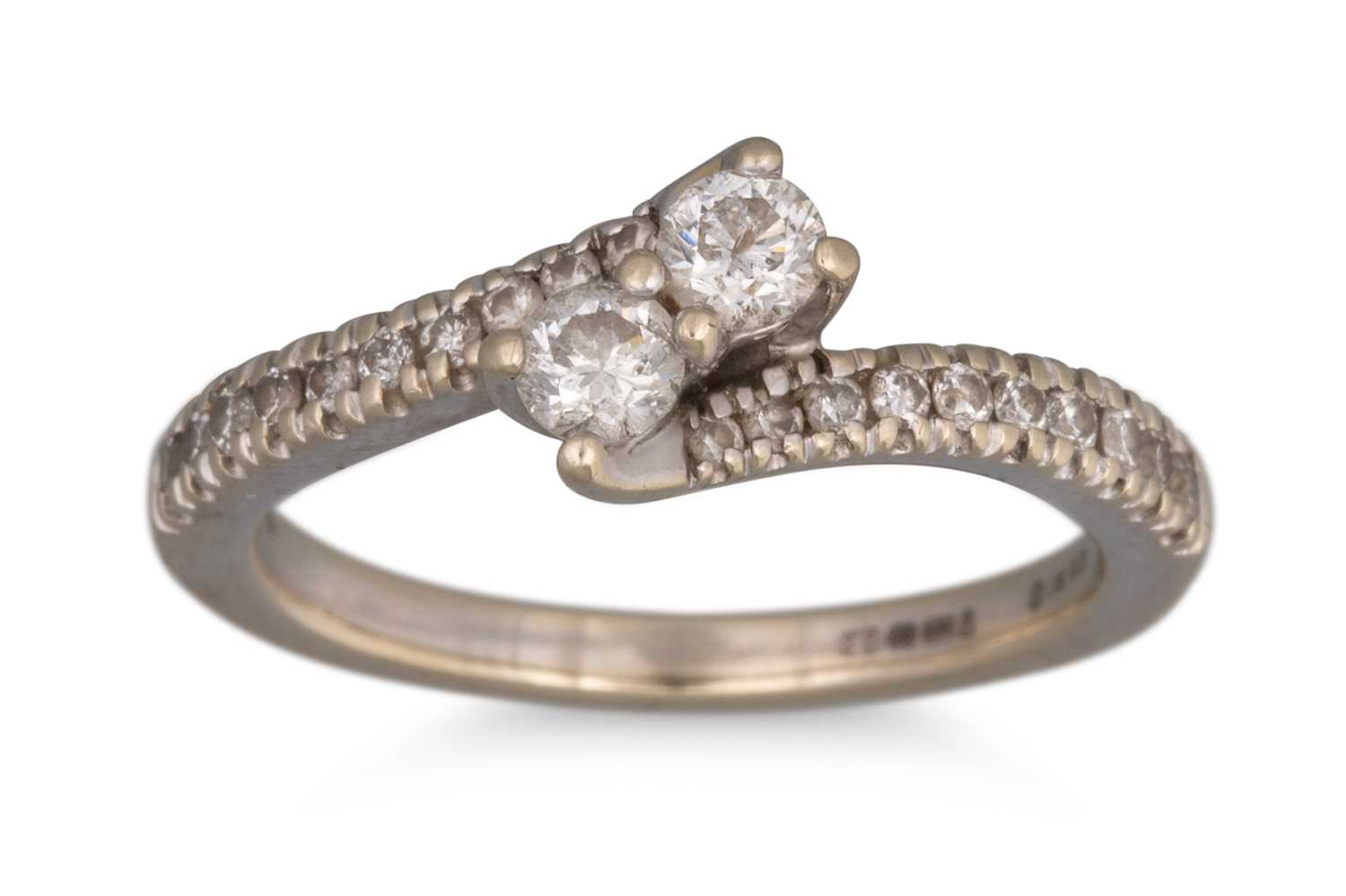 Lot 117 - A TWO STONE DIAMOND RING, of cross-over design,...