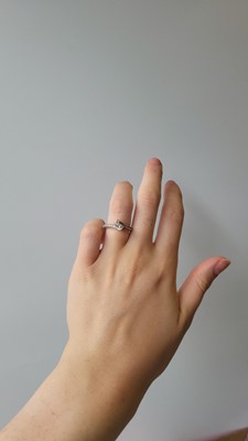 Lot 117 - A TWO STONE DIAMOND RING, of cross-over design,...