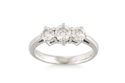 Lot 394 - A DIAMOND THREE STONE RING, mounted in...
