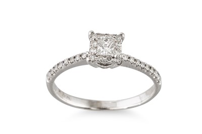 Lot 273 - A DIAMOND CLUSTER RING, set with a princess...