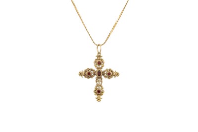Lot 24 - A GARNET SET CROSS, mounted in gold, shaped...