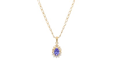 Lot 132 - A DIAMOND AND TANZANITE PENDANT, the oval...