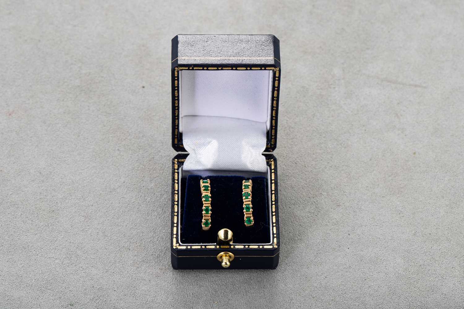 Lot 80 - A PAIR OF EMERALD HALF HOOP EARRINGS, the...