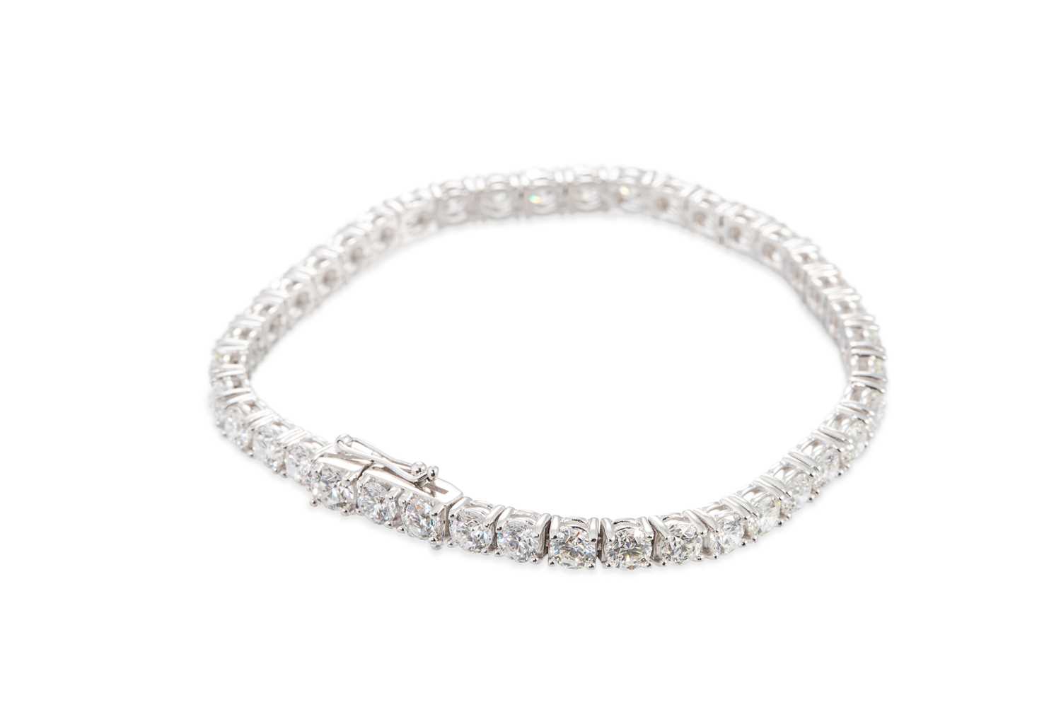 Lot 297 - A DIAMOND LINE BRACELET, the brilliant cut...