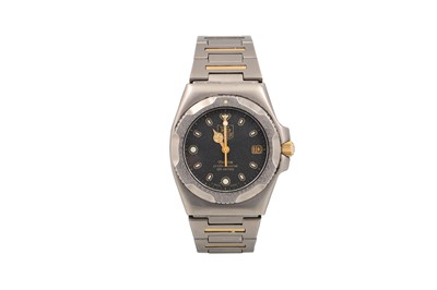 Lot 457 - A TAG HEUER TITANIUM WRIST WATCH, black face...