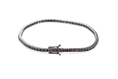 Lot 64 - A BLACK DIAMOND AND RUBY LINE BRACELET,...