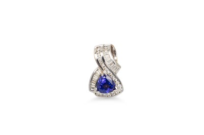 Lot 74 - A TANZANITE AND DIAMOND CLUSTER PENDANT, the...