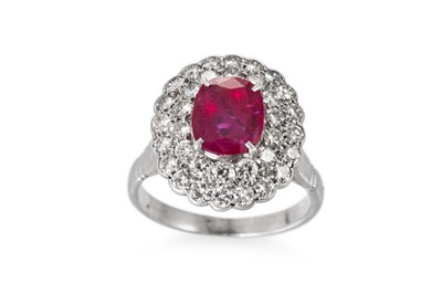 Lot 232 - A RUBY AND DIAMOND CLUSTER RING, the central...