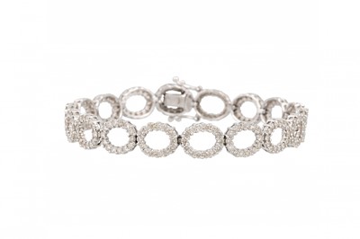 Lot 410 - A DIAMOND SET BRACELET, comprising open oval...
