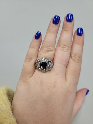 Lot 25 - A GARNET AND DIAMOND RETRO STYLE CLUSTER RING,...