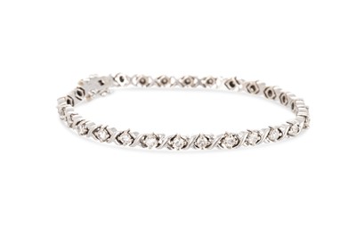 Lot 220 - A DIAMOND BRACELET, the round brilliant cut...