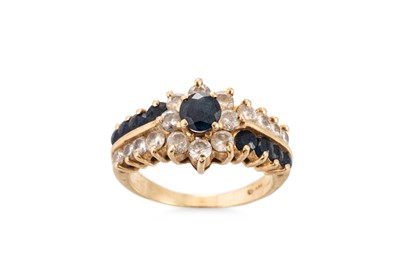 Lot 133 - A DIAMOND AND SAPPHIRE CLUSTER RING, the round...