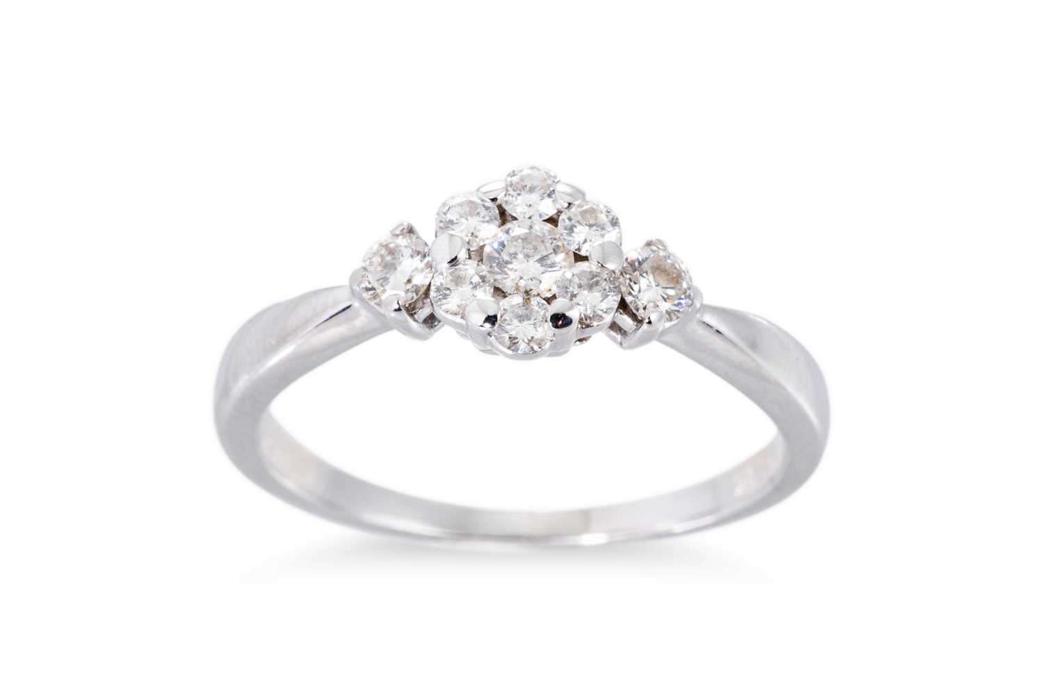 Lot 76 - A DIAMOND SET CLUSTER RING, the round...