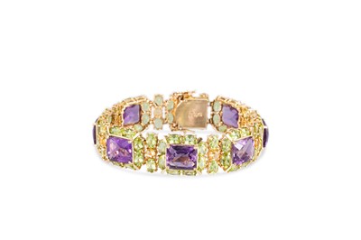 Lot 380 - AN AMETHYST AND PERIDOT SET CLUSTER BRACELET,...