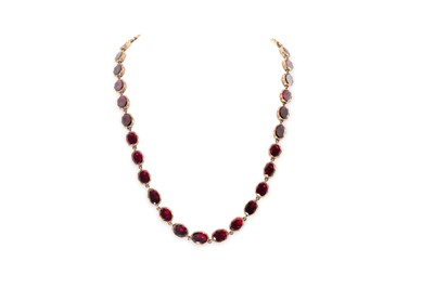 Lot 116 - A GEORGIAN GARNET RIVIERE NECKLACE, mounted in...