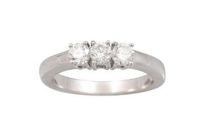 Lot 168 - A DIAMOND THREE STONE RING, the brilliant cut...