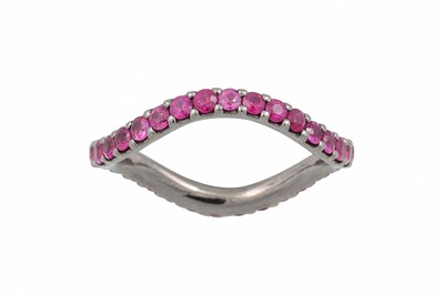 Lot 170 - A RUBY ETERNITY RING, of wavy style set with...