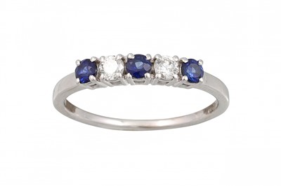 Lot 173 - A DIAMOND AND SAPPHIRE FIVE STONE RING, set...