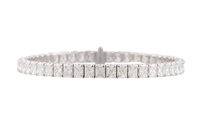 Lot 179 - A DIAMOND LINE BRACELET, the radiant cut...