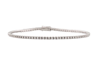 Lot 180 - A DIAMOND LINE BRACELET, the brilliant cut...