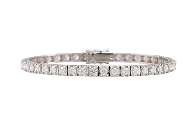 Lot 181 - A DIAMOND LINE BRACELET, the brilliant cut...