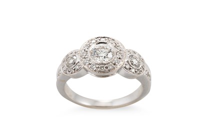 Lot 219 - A DIAMOND TRIPLE CLUSTER DRESS RING, mounted...