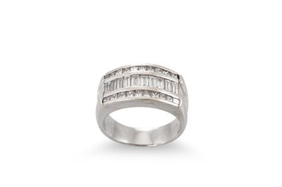Lot 172 - A DIAMOND THREED ROWED RING, the channel set...