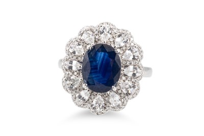 Lot 408 - A DIAMOND AND SAPPHIRE CLUSTER RING, mounted...
