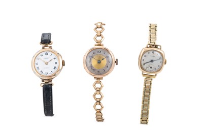 Lot 282 - THREE VINTAGE GOLD CASED WATCHES, straps are...
