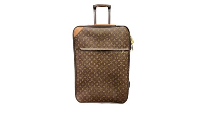Lot 519 - A LOUIS VUITTON SUITCASE, the canvas bag with...