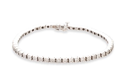 Lot 292 - A DIAMOND SET LINE BRACELET, the illusion set...