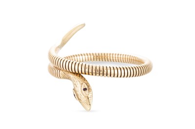Lot 324 - A VINTAGE 9CT YELLOW GOLD SNAKE BANGLE, of...