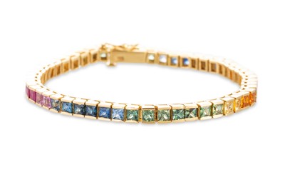 Lot 253 - A RAINBOW SAPPHIRE LINE BRACELET, mounted in...