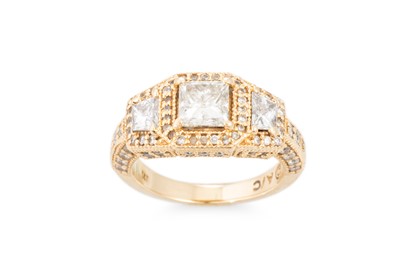 Lot 403 - A DIAMOND THREE STONE RING, the brilliant cut...