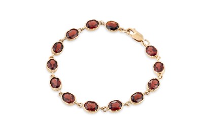 Lot 260 - A GARNET SET BRACELET, the oval garnets...