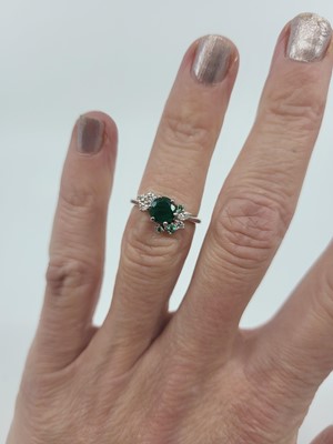 Lot 74 - AN EMERALD AND DIAMOND CLUSTER RING, mounted...