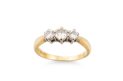 Lot 216 - A DIAMOND THREE STONE RING, the graduated...